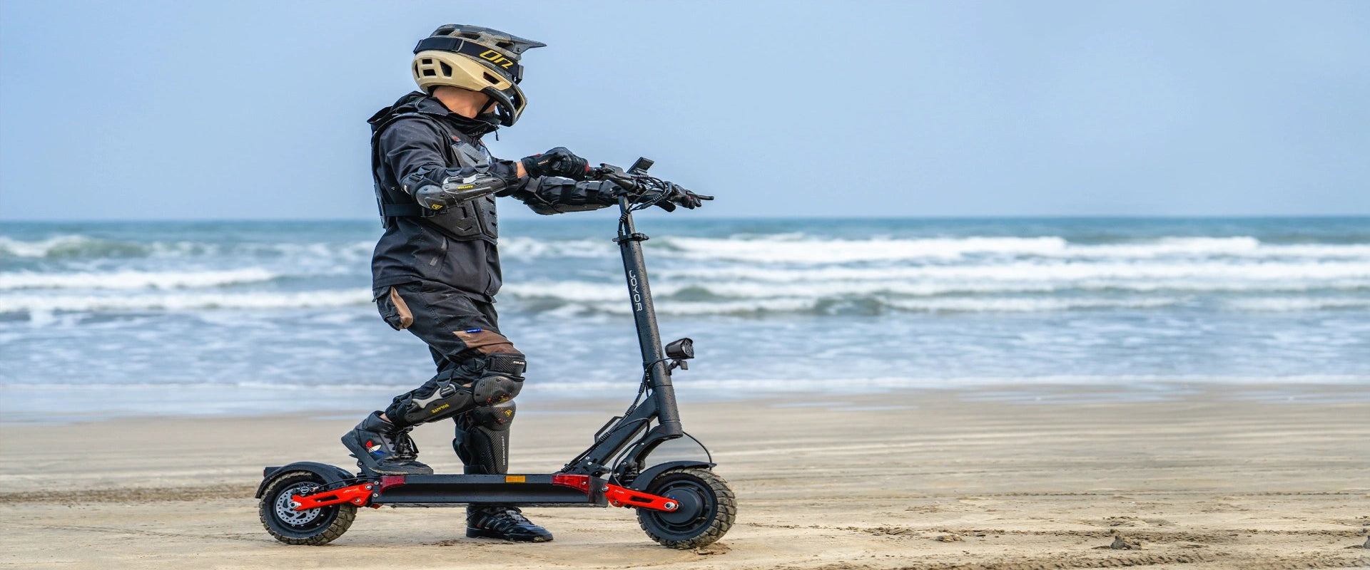 JOYOR T-PRO dual motor off-road electric scooter on seaside beach banner image